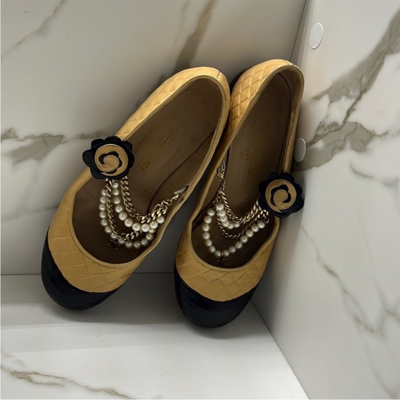 CHANEL Shoes - AUTHENTIC CHANEL Black and Tan Flats with Pearl Embellishments